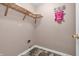 Cozy laundry room includes wood-look tile flooring and storage racks at 6045 Copeland Mills Ct, Indianapolis, IN 46221