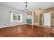 Spacious living room with beautiful wood floors, a modern chandelier, and plenty of natural light at 6045 Copeland Mills Ct, Indianapolis, IN 46221