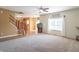 Bright living room with large window, neutral carpet, and easy access to the staircase and kitchen at 6045 Copeland Mills Ct, Indianapolis, IN 46221