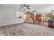 Comfortable living room with neutral carpet and a view into the kitchen and staircase at 6045 Copeland Mills Ct, Indianapolis, IN 46221