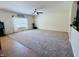 Spacious living room with neutral carpet and a large window with decorative curtains at 6045 Copeland Mills Ct, Indianapolis, IN 46221
