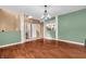 Open-concept living area with hardwood floors and views into the kitchen and entryway at 6045 Copeland Mills Ct, Indianapolis, IN 46221