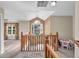 Cozy loft area featuring a view of the front yard and access to another bedroom at 6045 Copeland Mills Ct, Indianapolis, IN 46221