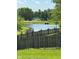 Pond in backyard seen through a wooden fence at 6045 Copeland Mills Ct, Indianapolis, IN 46221