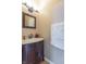 Charming powder room with a dark wood vanity and marble countertop at 6045 Copeland Mills Ct, Indianapolis, IN 46221