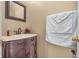 Elegant powder room with a decorative vanity, framed mirror, and classic fixtures at 6045 Copeland Mills Ct, Indianapolis, IN 46221