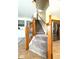 View of carpeted staircase leading upwards, framed by natural wood railing and tile flooring at 6045 Copeland Mills Ct, Indianapolis, IN 46221