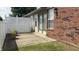 Patio area with a white fence, potted plants, and access to a door, perfect for relaxation at 6139 Robinwood Dr, Indianapolis, IN 46237