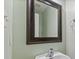 Powder room with sink and mirror with decorative frame at 618 Stobus Dr, Greenwood, IN 46143