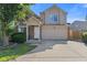 Charming two-story home featuring a front-facing garage, and a well-manicured front yard at 618 Stobus Dr, Greenwood, IN 46143
