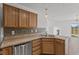 Kitchen featuring wood cabinets, stainless steel appliances, tile backsplash, and view to dining room at 618 Stobus Dr, Greenwood, IN 46143
