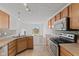 Bright kitchen with stainless steel appliances and tile backsplash open to dining and living areas at 618 Stobus Dr, Greenwood, IN 46143