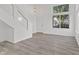 Bright, modern living room featuring gray floors, lots of light, and modern staircase at 618 Stobus Dr, Greenwood, IN 46143