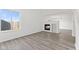 Bright living room with large windows and sleek gray flooring at 618 Stobus Dr, Greenwood, IN 46143