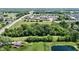 An aerial view of a lush green neighborhood with a pond and tree coverage at 6637 E County Road 600 S, Plainfield, IN 46168