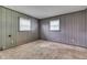 Bedroom with two windows, wall paneling, carpet, and neutral tones at 6637 E County Road 600 S, Plainfield, IN 46168