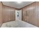 This bedroom features classic wood paneling, a doorway, and fair carpet at 6637 E County Road 600 S, Plainfield, IN 46168