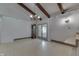 Expansive dining area with beamed ceilings, linoleum flooring, a wagon wheel chandelier, and adjacent patio access at 6637 E County Road 600 S, Plainfield, IN 46168