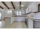 Bright kitchen featuring white cabinets, stainless steel appliances, a window over the sink and vintage chandelier at 6637 E County Road 600 S, Plainfield, IN 46168