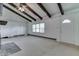 Open living room boasts beamed ceilings, neutral carpeting, and a large window providing natural light at 6637 E County Road 600 S, Plainfield, IN 46168