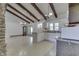 Open floor plan with kitchen and living room; vintage grandfather clock and exposed beams add charm at 6637 E County Road 600 S, Plainfield, IN 46168