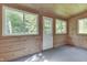 Enclosed porch with wood paneling and multiple windows offers views of the surrounding nature at 6637 E County Road 600 S, Plainfield, IN 46168