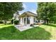 A spacious backyard features a patio area, lush greenery, and mature trees at 6656 Easy St, Fishers, IN 46038