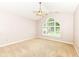Bright bedroom features a ceiling fan and a large arched window overlooking a green lawn at 6656 Easy St, Fishers, IN 46038