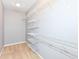 Walk-in closet boasts adjustable white wire shelving for customizable storage solutions at 6656 Easy St, Fishers, IN 46038