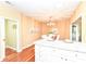 Bright dining area features stylish chandelier, wood table, seating for six and opens to the kitchen at 6656 Easy St, Fishers, IN 46038