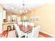 Bright dining area features stylish chandelier, wood table, seating for six and opens to the kitchen at 6656 Easy St, Fishers, IN 46038
