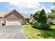 Charming brick home featuring a two-car garage and well-maintained landscaping at 6656 Easy St, Fishers, IN 46038