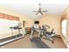 Home gym equipped with treadmills, elliptical, weights, and a mounted TV at 6656 Easy St, Fishers, IN 46038