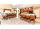 View of the dining and kitchen areas with wood cabinets, stone countertops, and pendant lighting at 6656 Easy St, Fishers, IN 46038