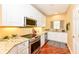 Well-lit kitchen features stainless steel appliances, granite countertops, white cabinetry and hardwood floors at 6656 Easy St, Fishers, IN 46038