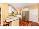 Well-lit kitchen features stainless steel appliances, granite countertops, white cabinetry and hardwood floors at 6656 Easy St, Fishers, IN 46038