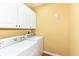 Bright laundry room features a washer and dryer and lots of cabinets for storage at 6656 Easy St, Fishers, IN 46038