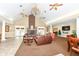 A cozy living room featuring a brick fireplace, tan walls, and plush leather seating for relaxing at 6656 Easy St, Fishers, IN 46038