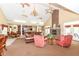 Bright living room featuring a brick fireplace, chandelier, ceiling fans, and comfortable seating arrangement at 6656 Easy St, Fishers, IN 46038