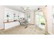Bright office space features built-in shelving, a glass desk and sliding glass doors to the backyard at 6656 Easy St, Fishers, IN 46038