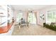 Bright office space features built-in shelving, a glass desk and sliding glass doors to the backyard at 6656 Easy St, Fishers, IN 46038