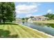 Scenic view of a community pond with a fountain, surrounded by lush greenery at 6656 Easy St, Fishers, IN 46038