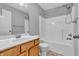 Bathroom featuring wood vanity with sink and shower over tub with tile floors at 6686 Woodcrest Dr, Avon, IN 46123