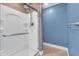 Modern bathroom featuring a multi-head shower with glass door and stylish wood accent wall at 6686 Woodcrest Dr, Avon, IN 46123