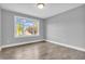 Inviting bedroom with wood-look floors and a large window offering a pleasant view at 6686 Woodcrest Dr, Avon, IN 46123