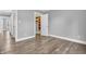 Gray bedroom with wood-look floors with views of closet and hallway in neutral color palate at 6686 Woodcrest Dr, Avon, IN 46123