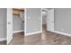 Neutral bedroom with ample closet space and view into adjacent living area with modern chandelier at 6686 Woodcrest Dr, Avon, IN 46123