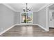 Elegant dining room featuring hardwood floors, a modern chandelier, and a large window at 6686 Woodcrest Dr, Avon, IN 46123