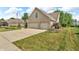 Beautiful brick home with a manicured lawn and a three car garage at 6686 Woodcrest Dr, Avon, IN 46123