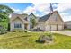 Attractive brick home showcasing a lush green lawn and beautiful landscaping on a sunny day at 6686 Woodcrest Dr, Avon, IN 46123